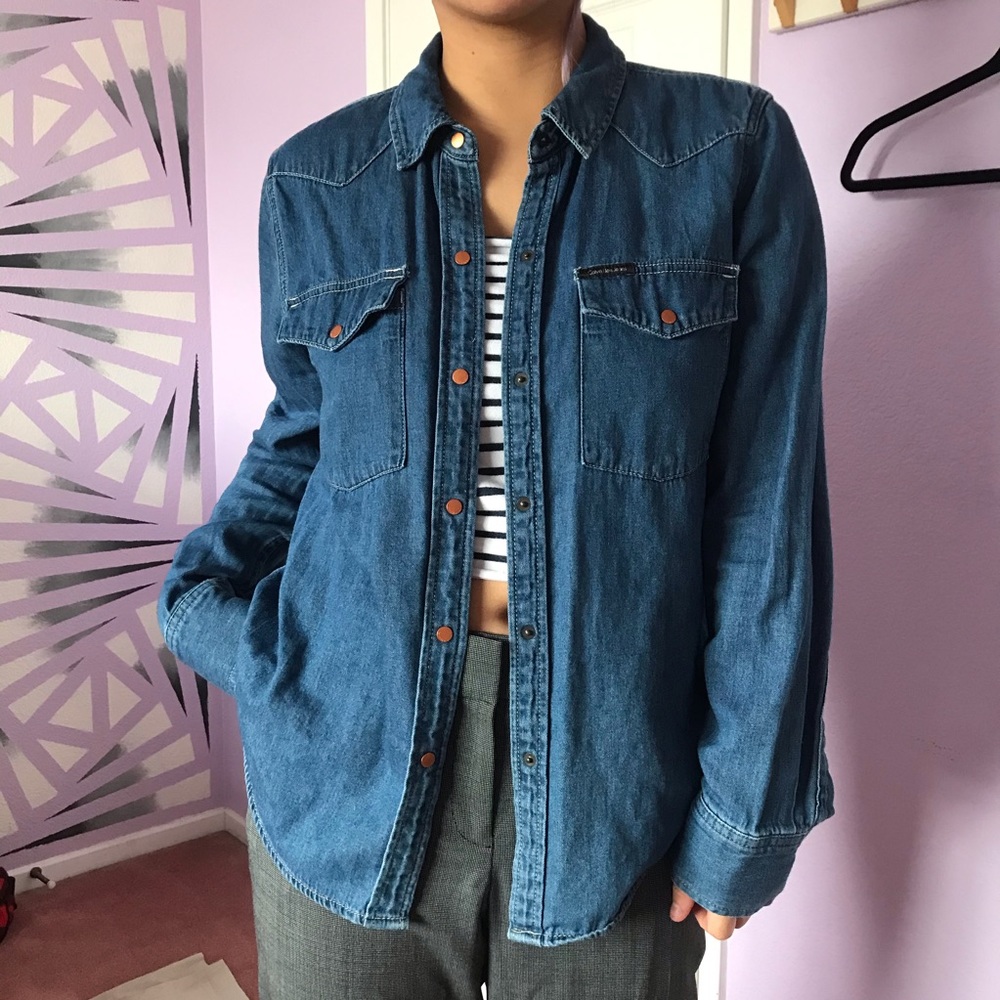 Calvin Klein jeans and a button down shirt